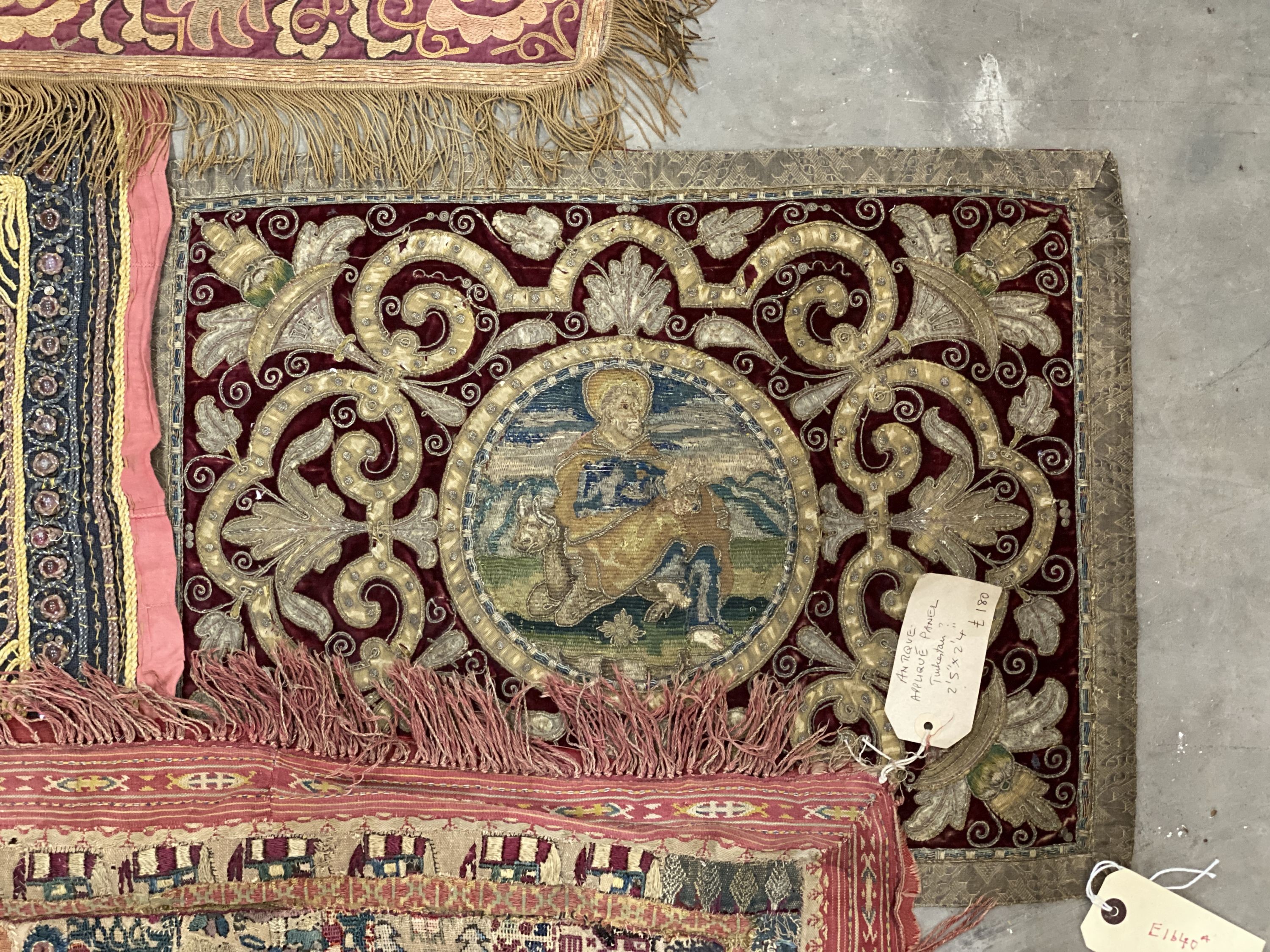 An Indian appliqué panel, two Indian appliqué covers and one other.